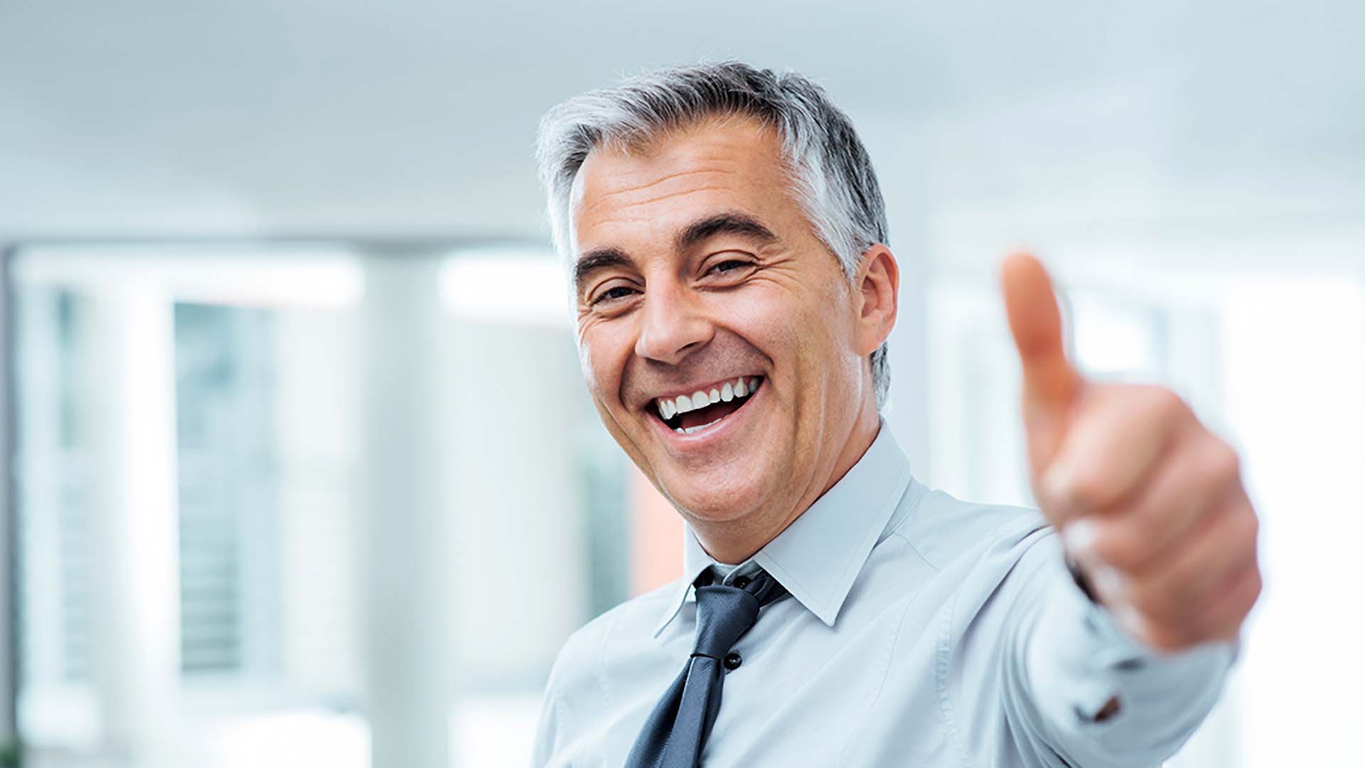 Happy business owner giving a thumbs-up after a successful website redesign.