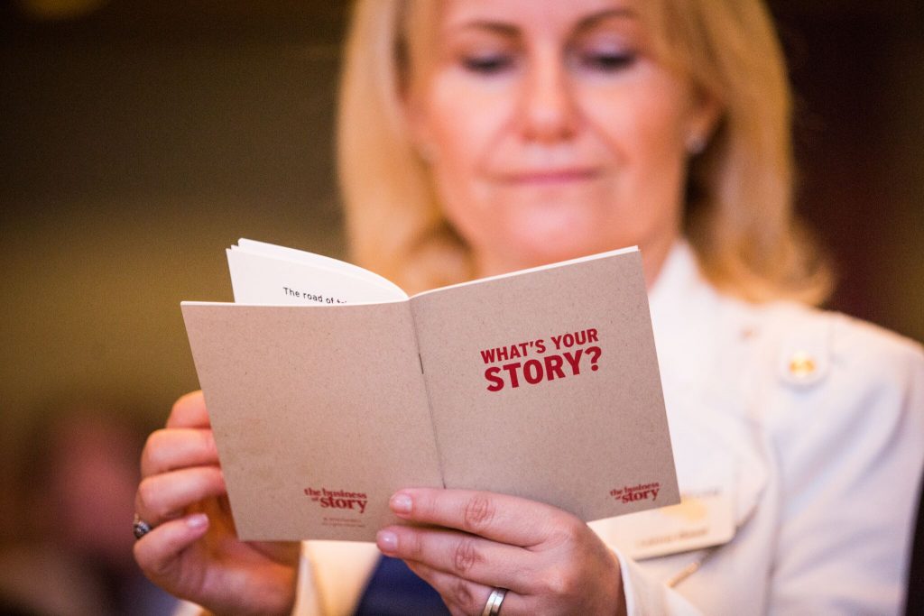 business leader reading a book about her story that shows how the right kind of brand storytelling is critical to your content creation strategy.